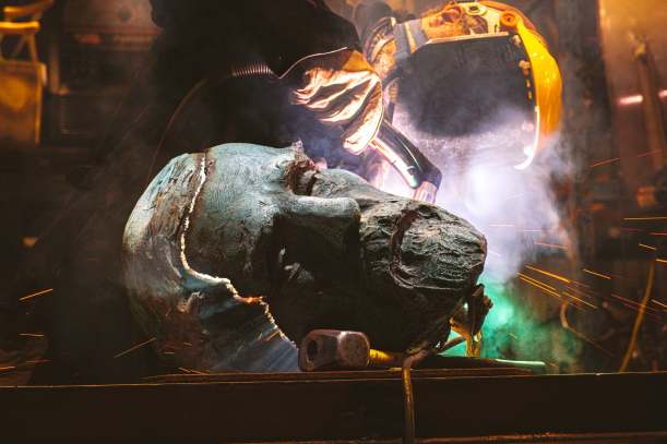 Face of a Robert E. Lee Statue being cut by a welding torch